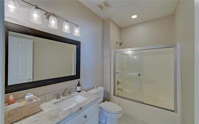 an aerial view of a tennis ground and a large tree