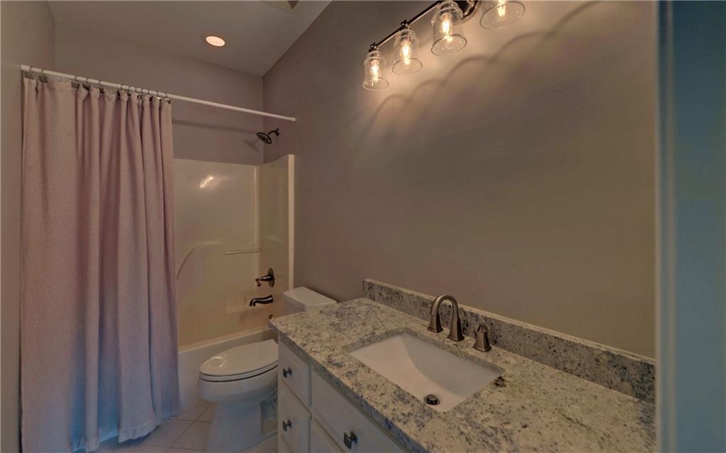 2760 Camp Branch Road Buford, GA 30519 - Photo 51 of 73 a bathroom with a granite countertop sink toilet and shower
