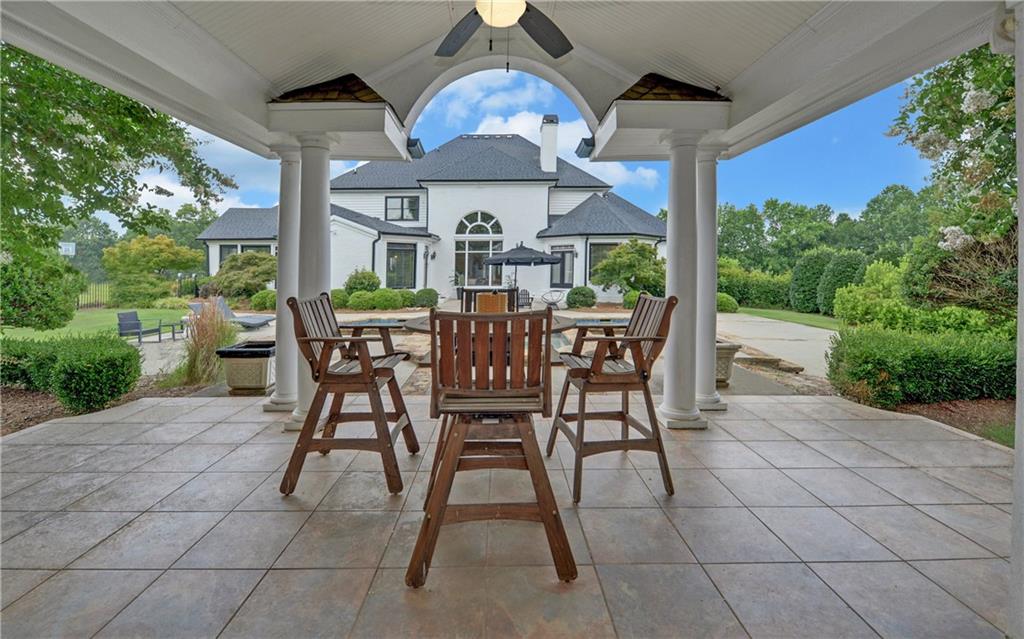 2760 Camp Branch Road Buford, GA 30519 - Photo 59 of 73 a view of a patio with a table and chairs under an umbrella