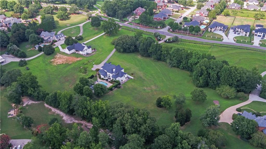2760 Camp Branch Road Buford, GA 30519 - Photo 65 of 73 a view of a house with a big yard and potted plants