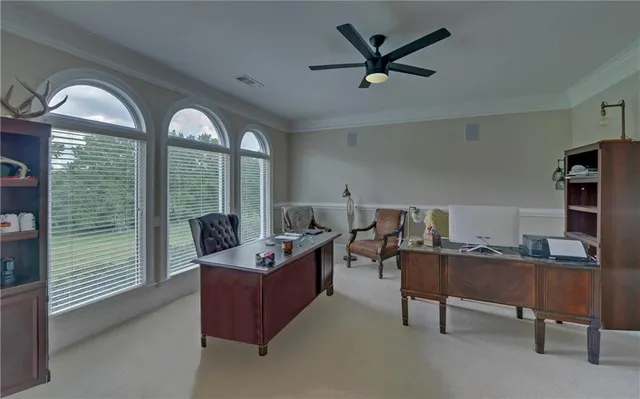 a living room with furniture large window and wooden floor