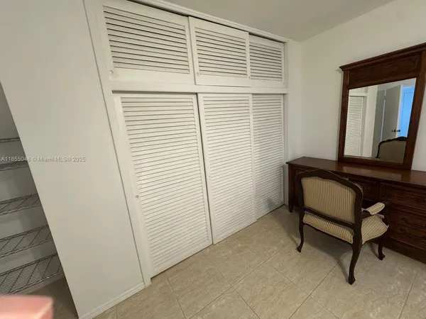 a en suite bathroom with a sink and mirror with bathtub