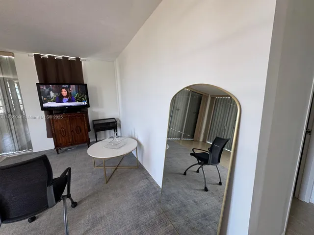 a living room with furniture and a tv