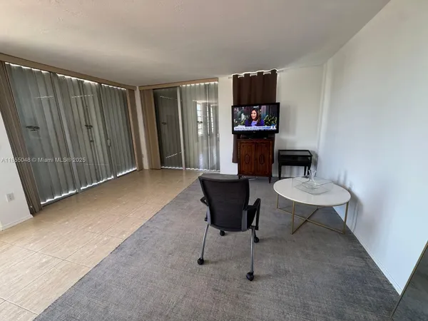 a living room with furniture a rug and a wall painting
