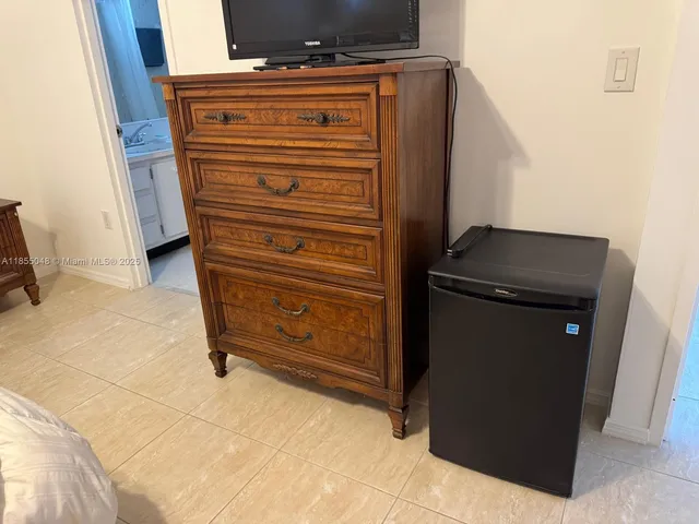 a room with a bed and a cabinets