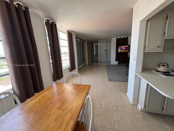 a view of a kitchen with furniture and a window