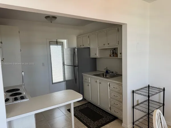a kitchen with stainless steel appliances a refrigerator and a stove top oven