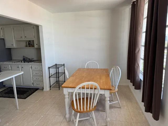 a kitchen with a stove top oven and cabinets