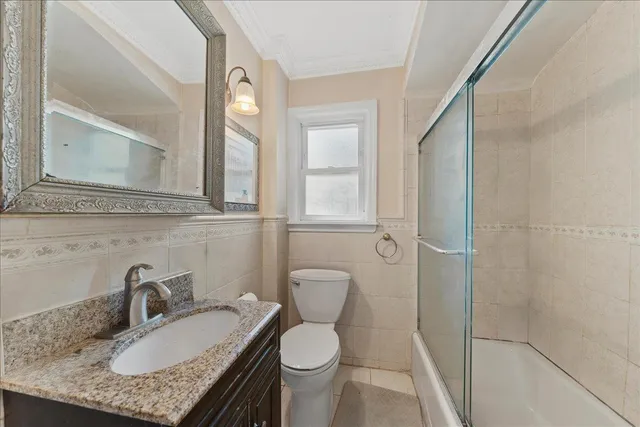 a bathroom with a granite countertop sink a toilet and a mirror