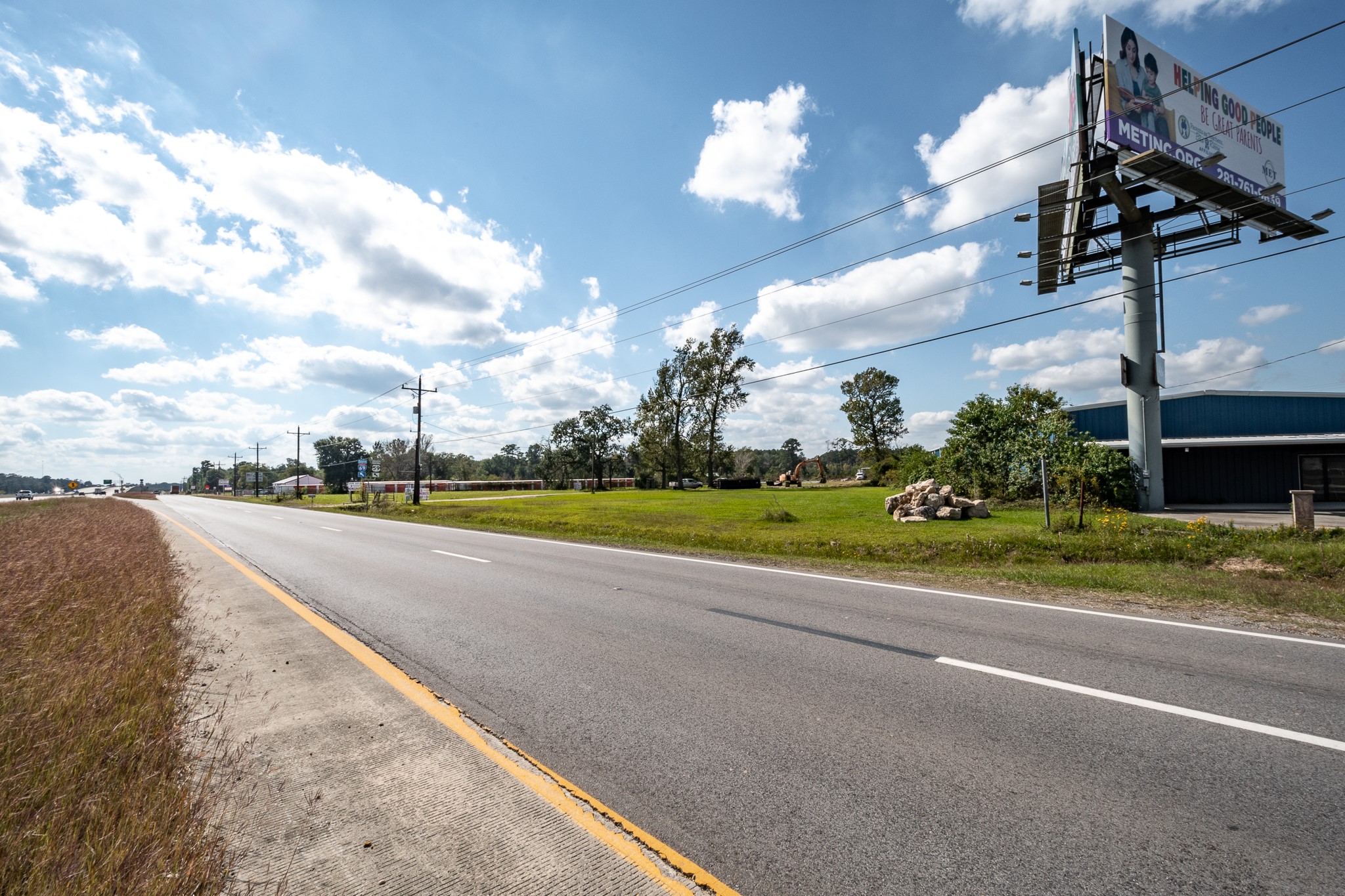 12794 Highway 59 Splendora, TX 77372 - Photo 5 of 12 a view of a house with a big yard and a large tree