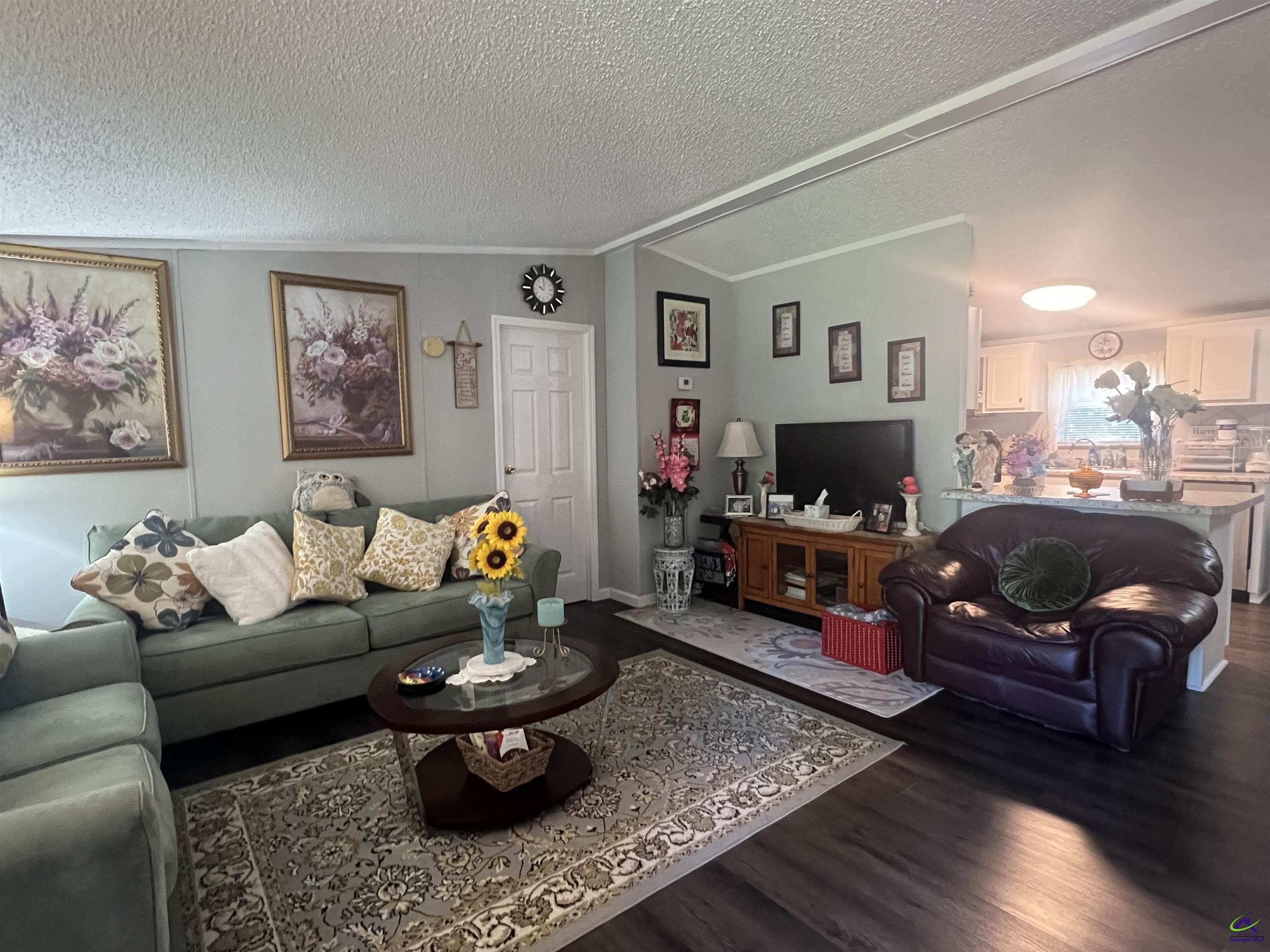 166 Pebble Hills Road Cochran, GA 31014 - Photo 7 of 27 a living room with furniture and a fireplace