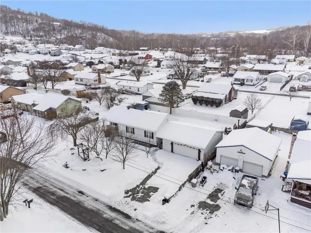 an aerial view of a residential houses with outdoor space