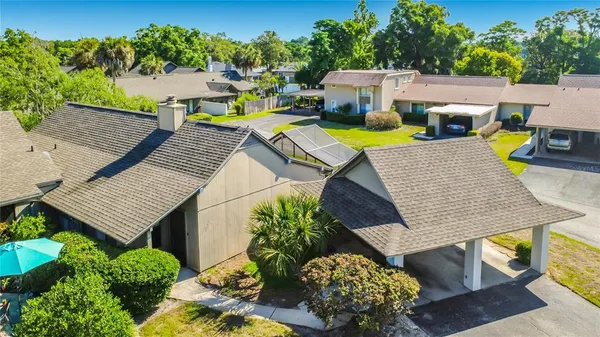 an aerial view of a house with patio outdoor seating