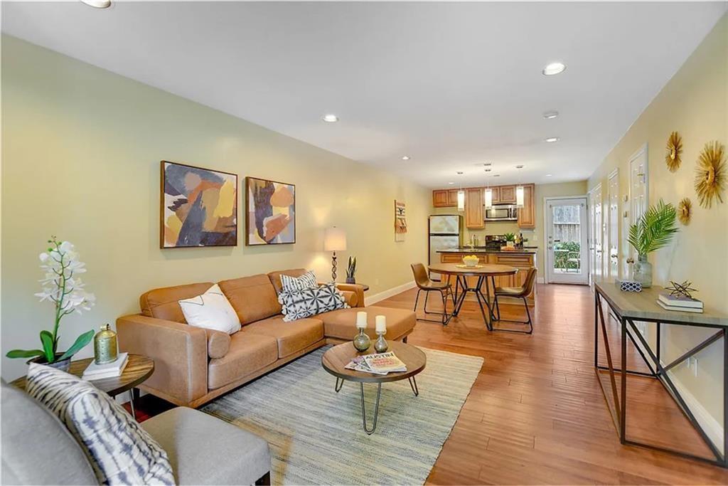 a living room with furniture and wooden floor