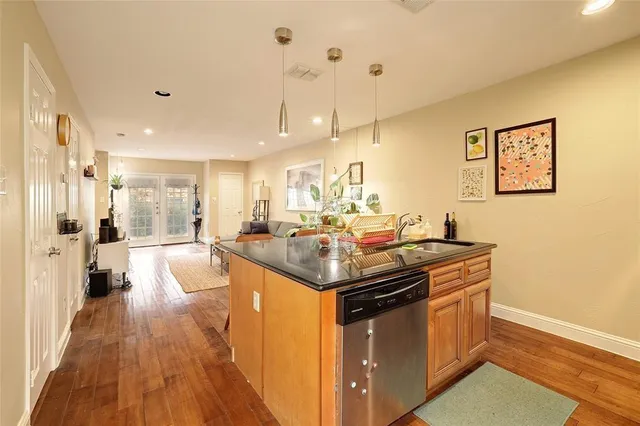 a kitchen with a stove and a wooden floor