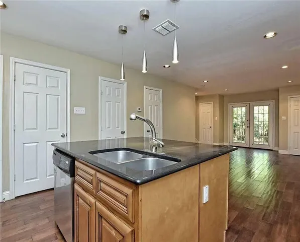 a kitchen with granite countertop a sink and window
