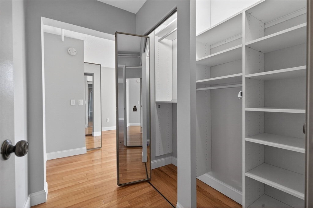 1731 Beacon Street, Unit 1210 Brookline, MA 02445 - Photo 14 of 32 a view of a bathroom with wooden floor and a glass door