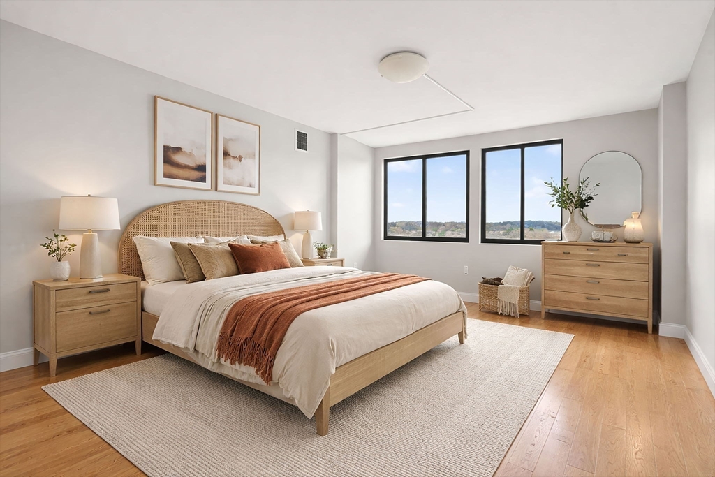 1731 Beacon Street, Unit 1210 Brookline, MA 02445 - Photo 15 of 32 a spacious bedroom with a bed and a dresser