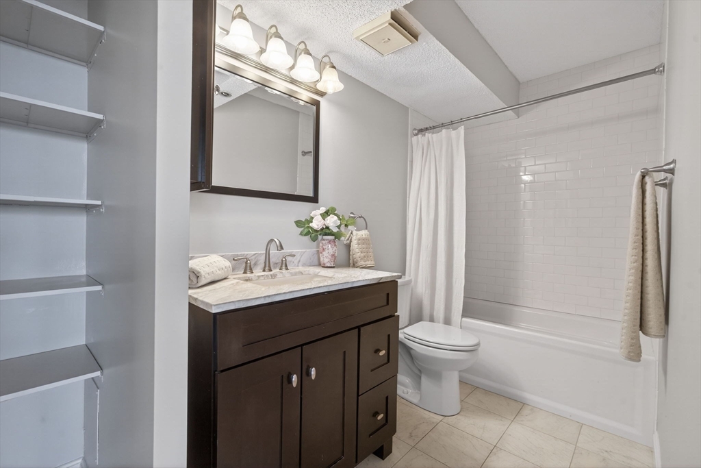 1731 Beacon Street, Unit 1210 Brookline, MA 02445 - Photo 16 of 32 a bathroom with a sink toilet and shower