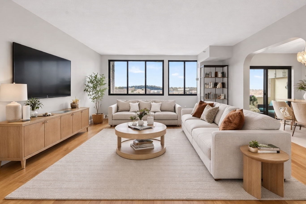 1731 Beacon Street, Unit 1210 Brookline, MA 02445 - Photo 3 of 32 a living room with furniture and a flat screen tv