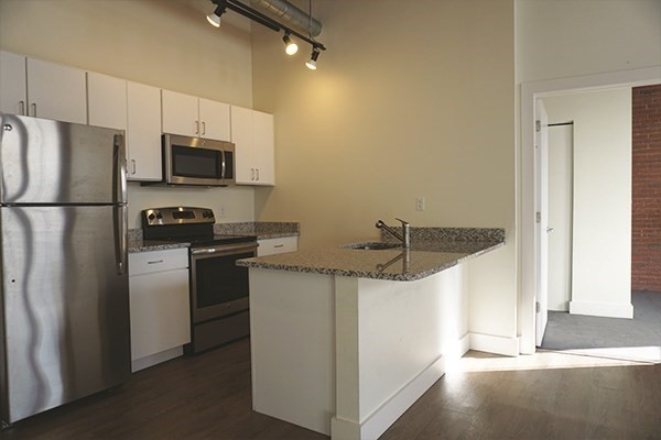 60 Water Street, Unit 2006 North Andover, MA 01845 - Photo 2 of 17 a kitchen with stainless steel appliances a refrigerator a stove a microwave and white cabinets