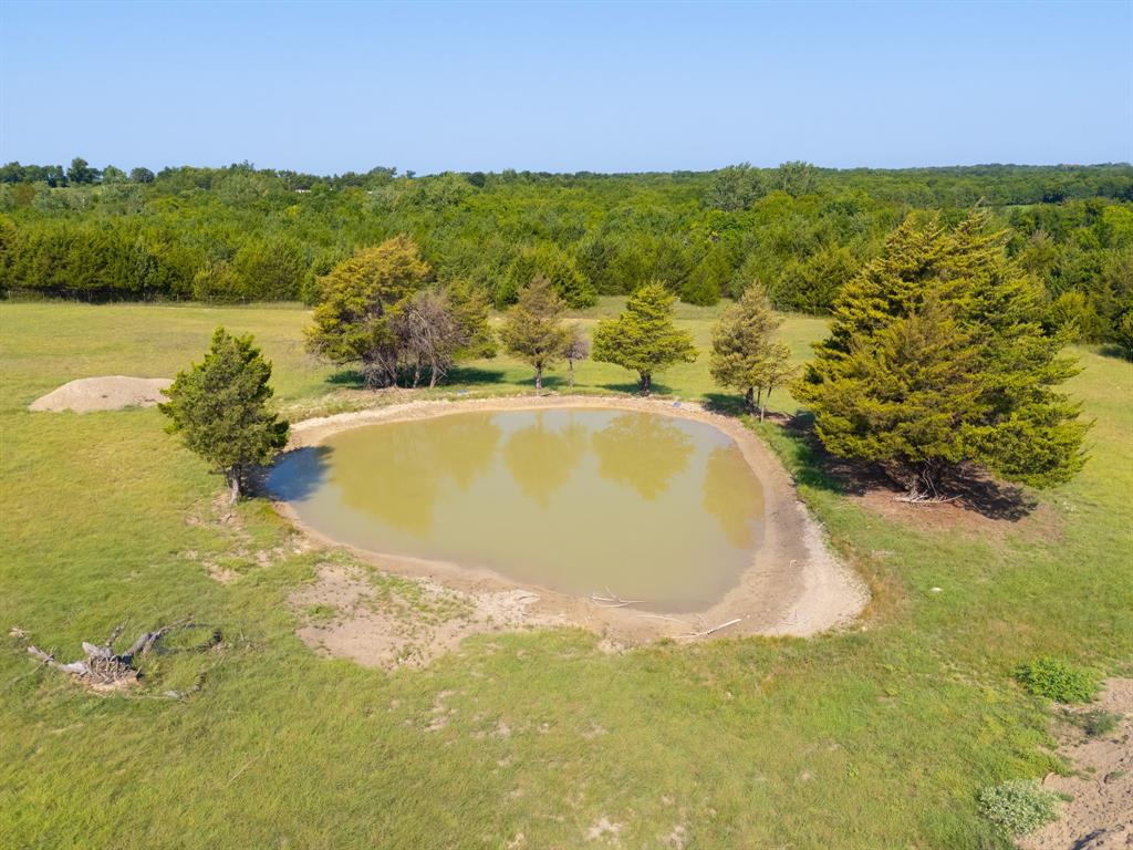 511 County Road 2765 Windom, TX 75492 - Photo 5 of 10 a view of a lake with a house in the background