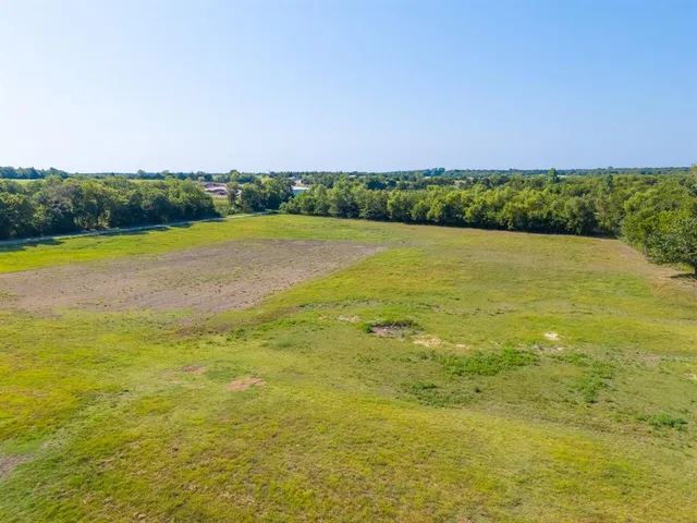 a view of pool with umbrella and wooden fence