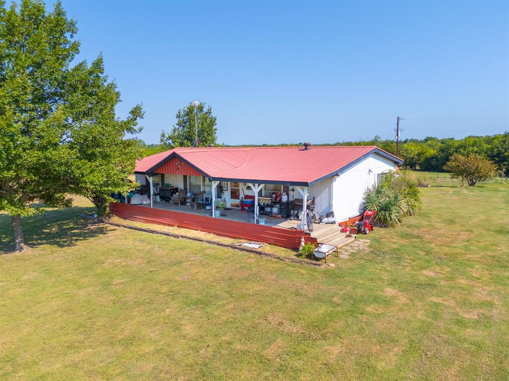 511 County Road 2765 Windom, TX 75492 - Photo 8 of 10 a view of pool with umbrella and wooden fence
