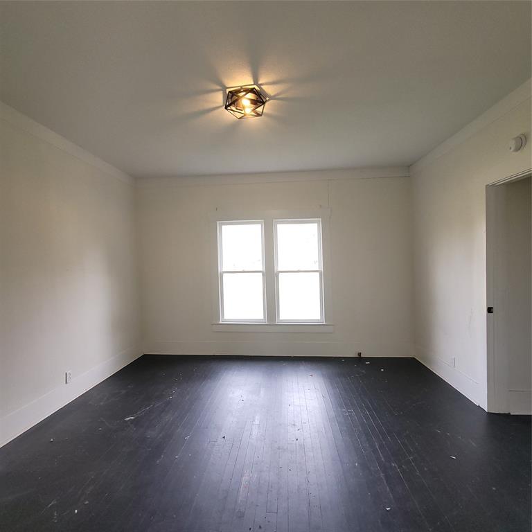 410 Southwest 3rd Street Kerens, TX 75144 - Photo 14 of 21 a view of an empty room with wooden floor and a window