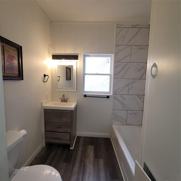 410 Southwest 3rd Street Kerens, TX 75144 - Photo 17 of 21 a bathroom with a sink a toilet and shower