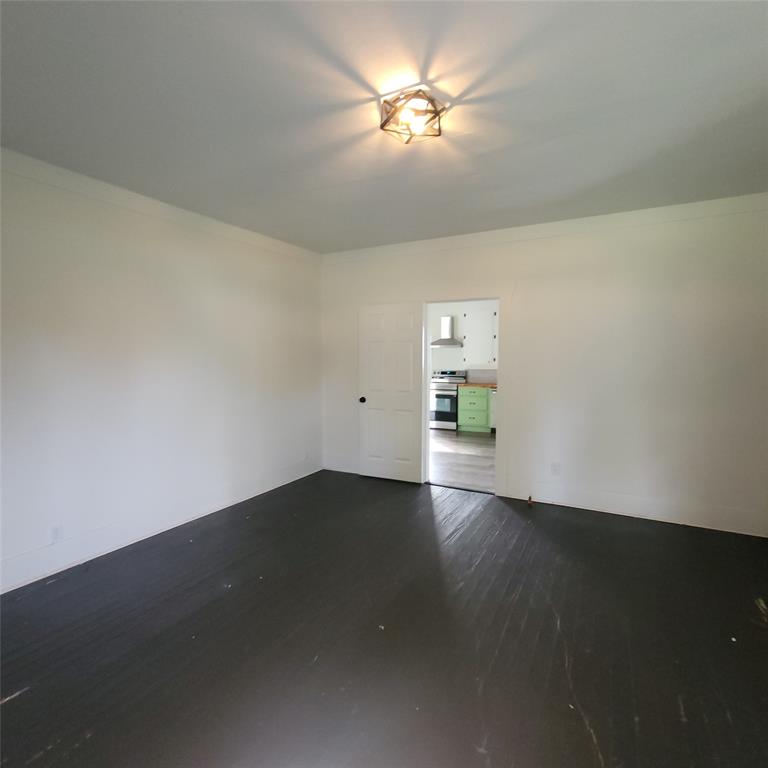 410 Southwest 3rd Street Kerens, TX 75144 - Photo 4 of 21 a view of empty room with wooden floor and fan