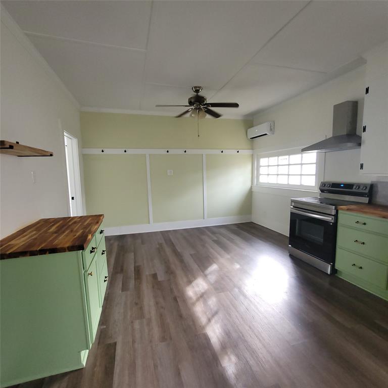 410 Southwest 3rd Street Kerens, TX 75144 - Photo 5 of 21 wooden floor in an empty room with a window