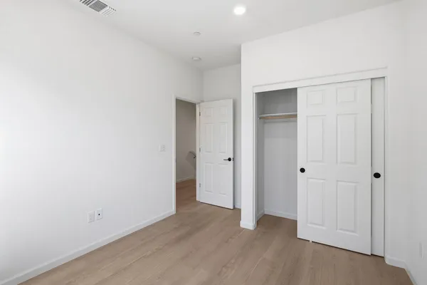 an empty room with closet area