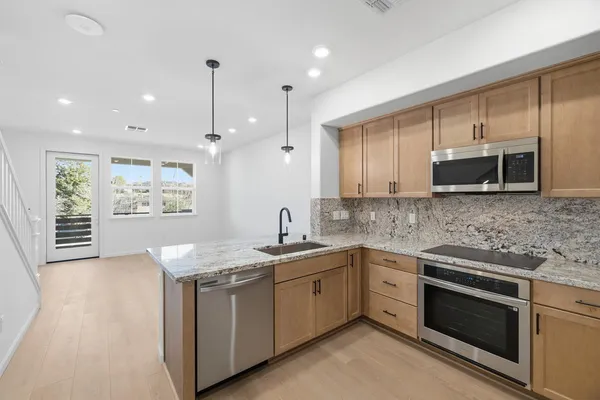 a kitchen with a sink stove and microwave