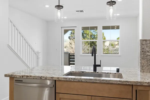 a kitchen with granite countertop a sink and a window