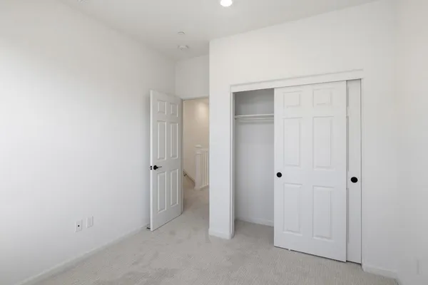 an empty room with closet area
