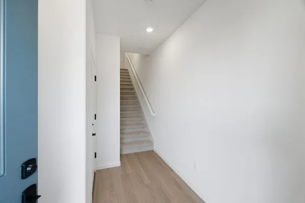 a view of a hallway with wooden floor