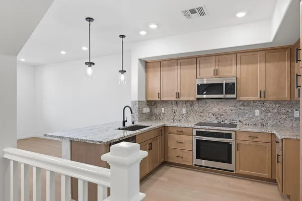 a kitchen with a sink stove and microwave
