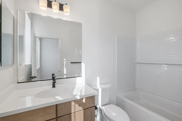 a bathroom with a sink a toilet and bathtub