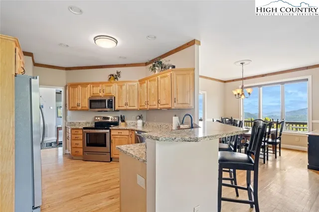 a bedroom with a bed and dresser with mirror
