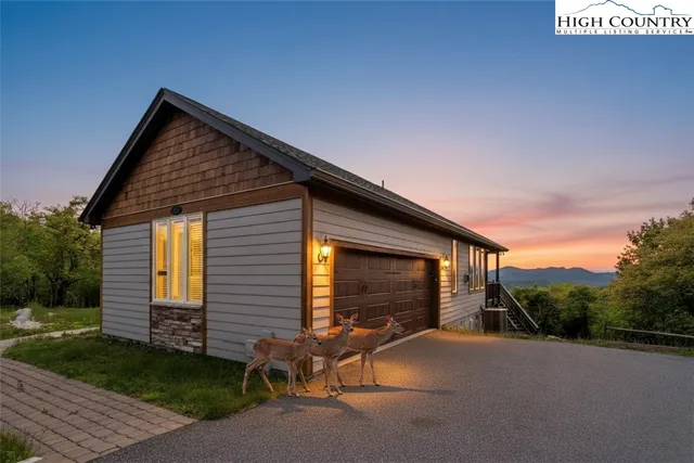 a living room with furniture a fireplace and a large window