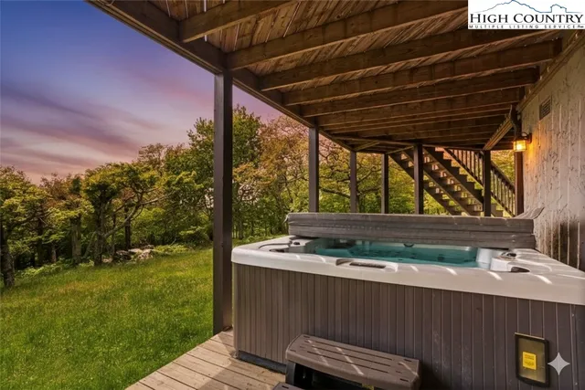 a kitchen with stainless steel appliances granite countertop a refrigerator a stove and a sink with wooden floor