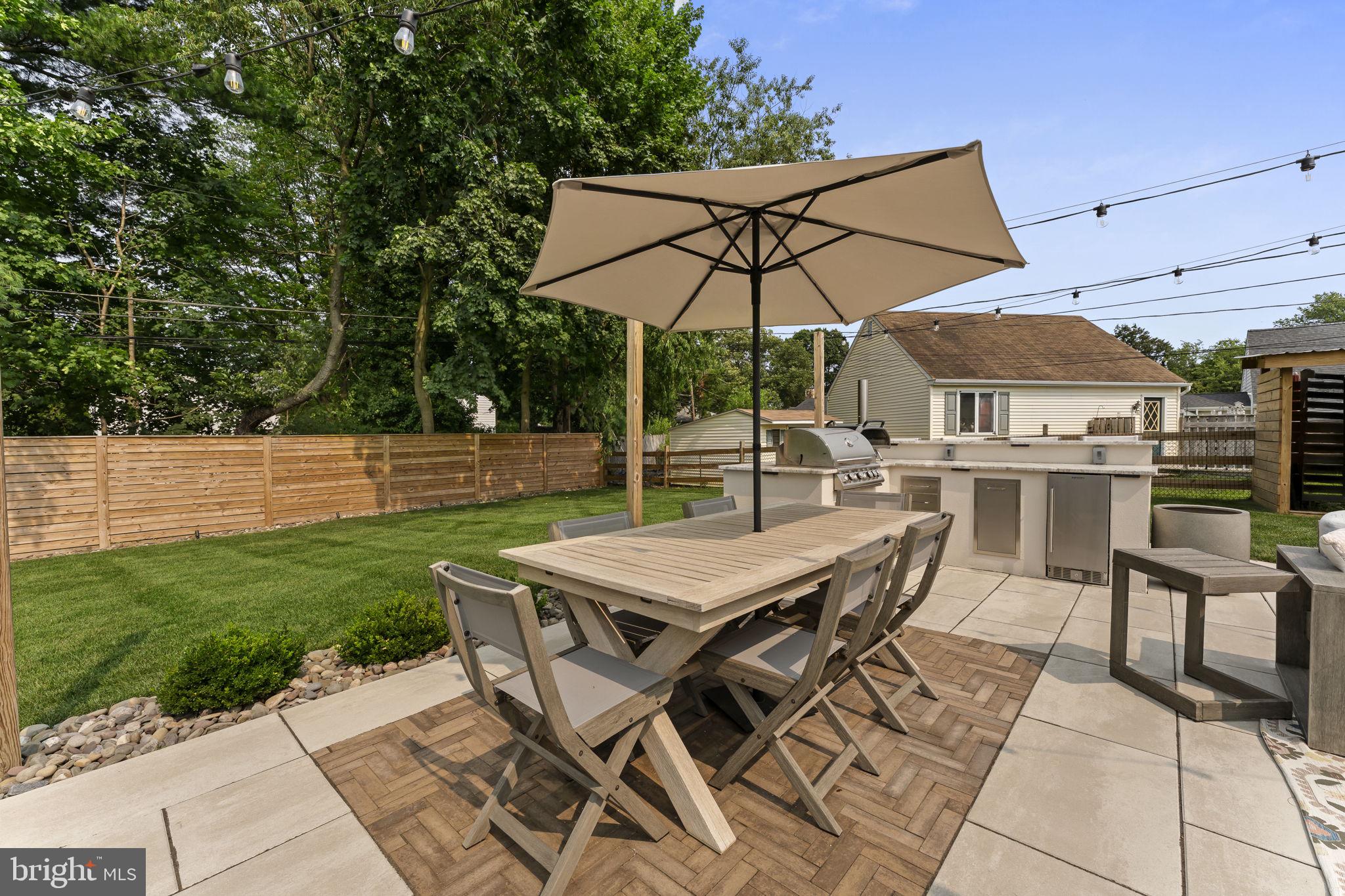 113 Manor Road Paoli, PA 19301 - Photo 35 of 44 an outdoor space with furniture and umbrella