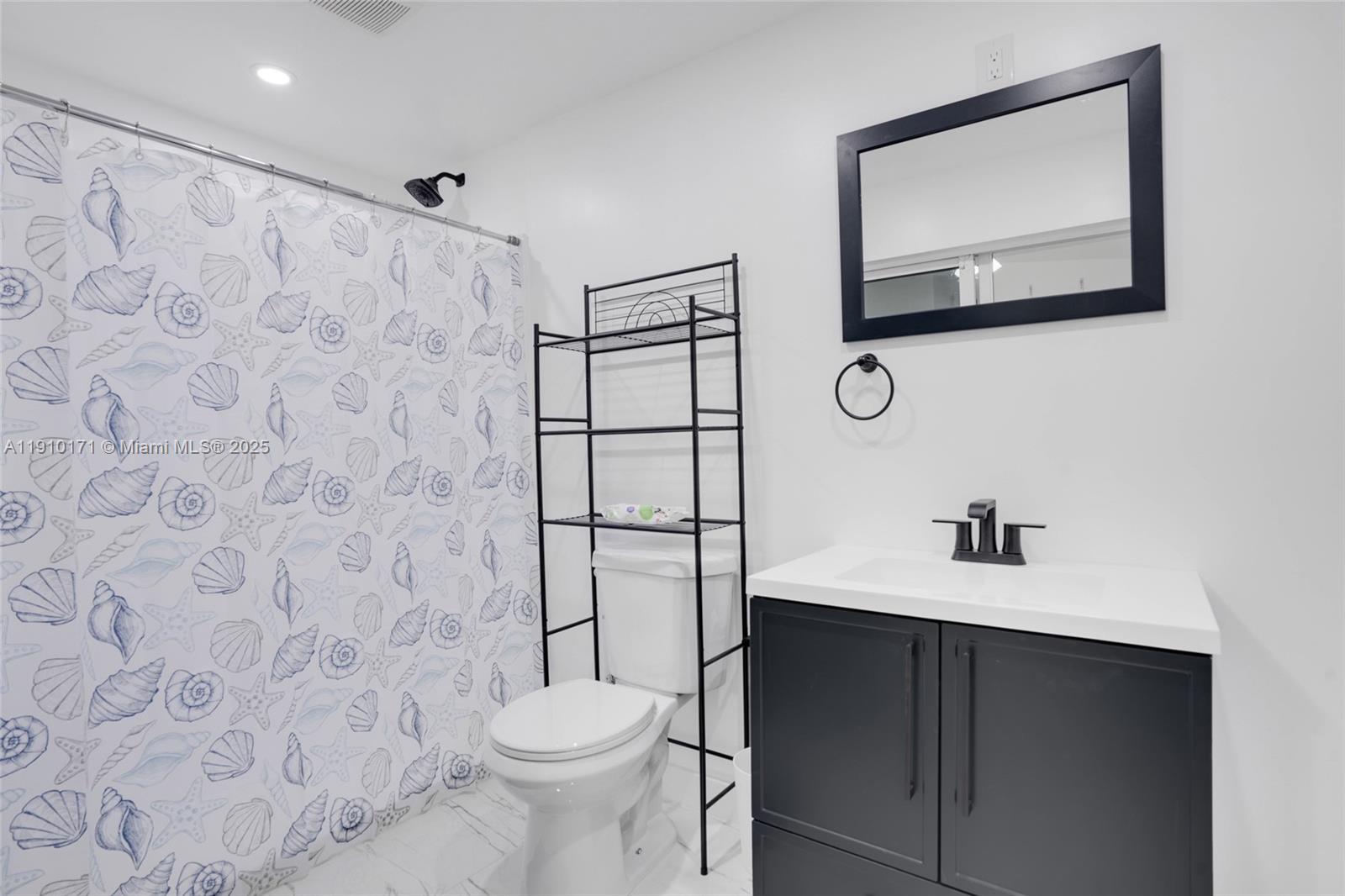 12068 Southwest 210th Street Miami, FL 33177 - Photo 11 of 19 a bathroom with a sink toilet and mirror