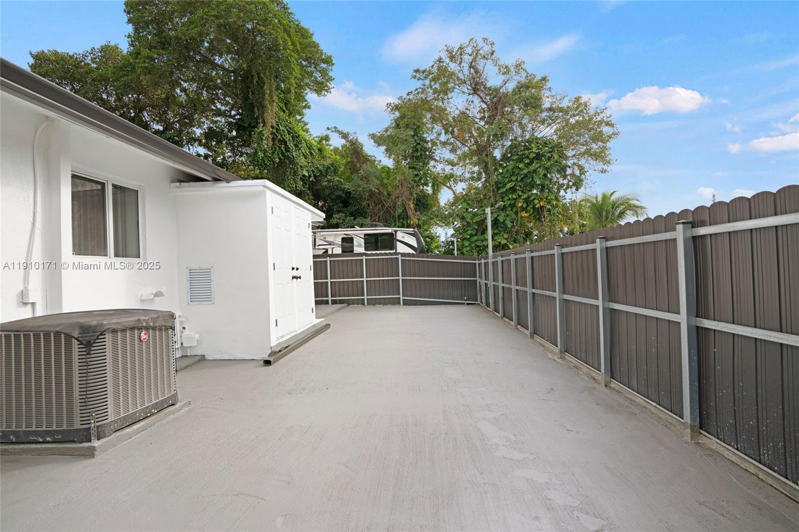 12068 Southwest 210th Street Miami, FL 33177 - Photo 18 of 19 a view of a backyard with fence and trees