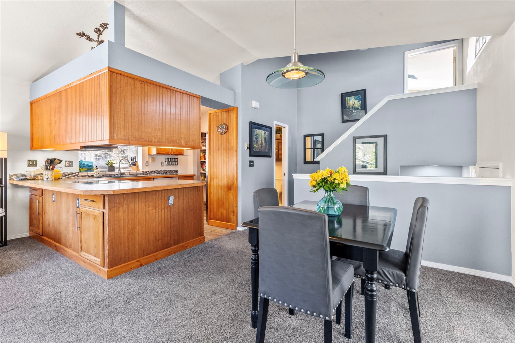 654 Alpine Road Dillon, CO 80435 - Photo 17 of 40 Carpeted dining room with high vaulted ceiling and sink