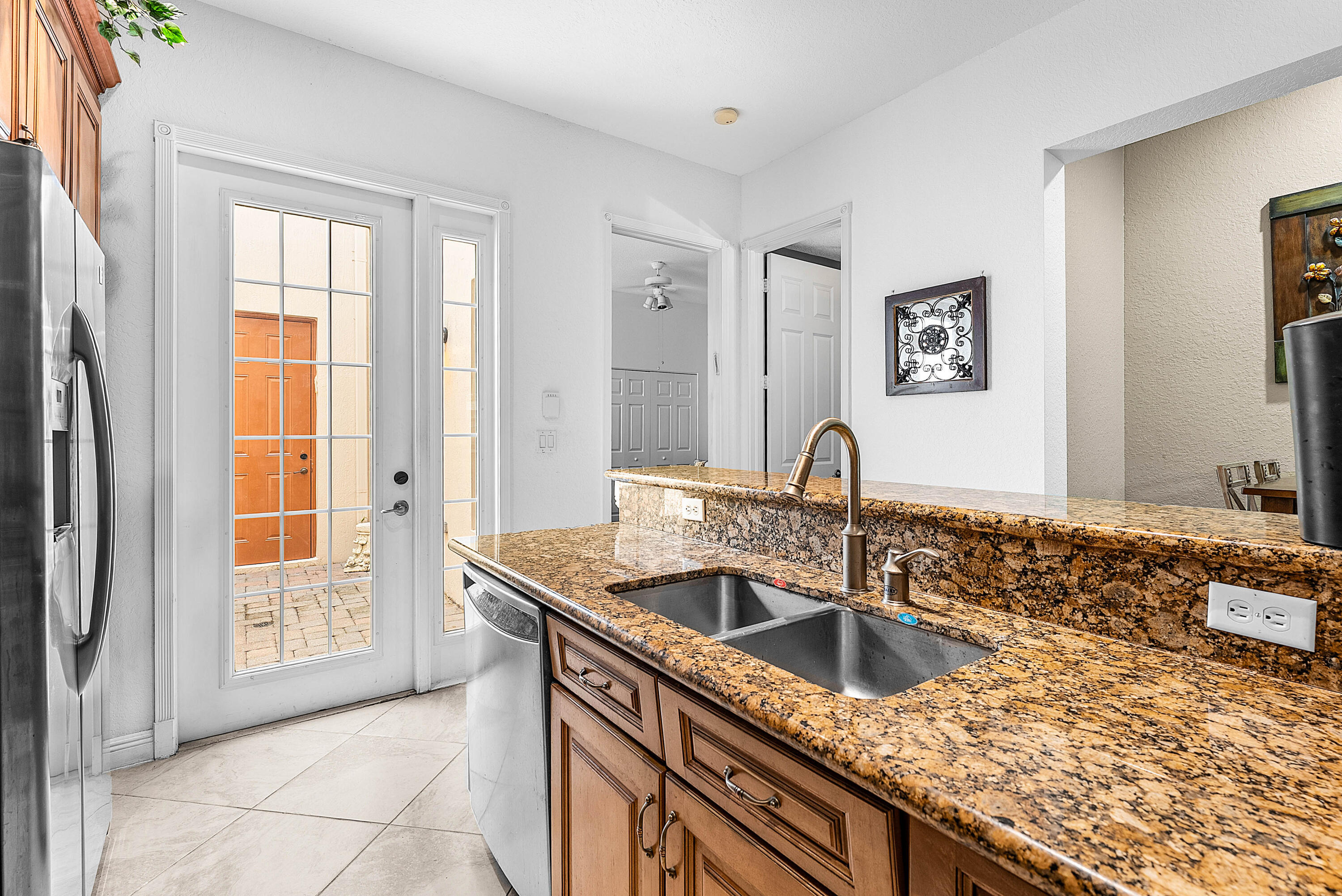 8309 Northwest 8th Way Boca Raton, FL 33487 - Photo 12 of 39 a kitchen with granite countertop a sink and a window