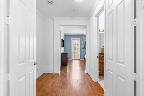 a view of a hallway with wooden floor