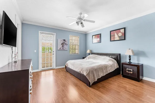 a spacious bedroom with a bed and a flat screen tv