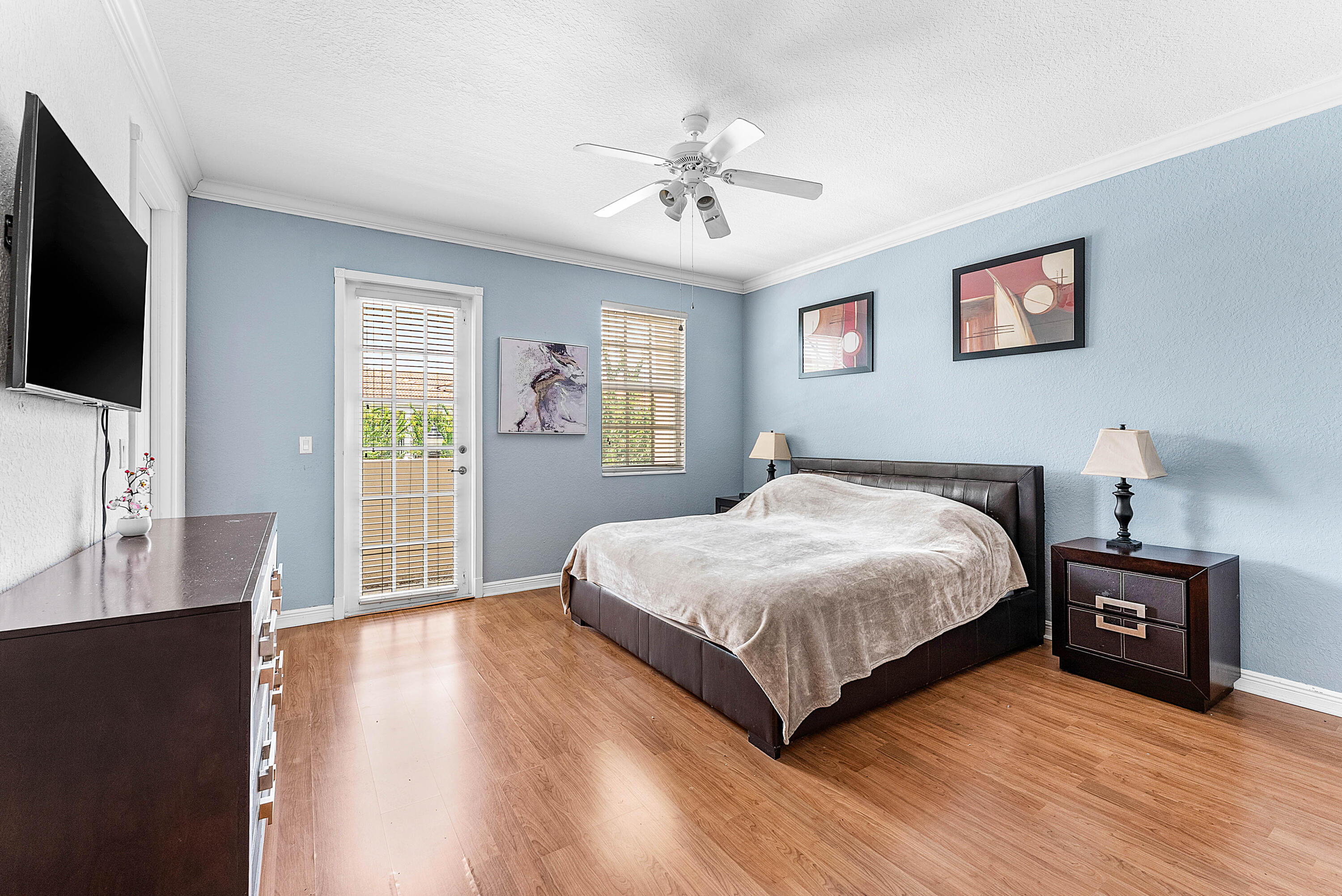 8309 Northwest 8th Way Boca Raton, FL 33487 - Photo 15 of 39 a spacious bedroom with a bed and a flat screen tv